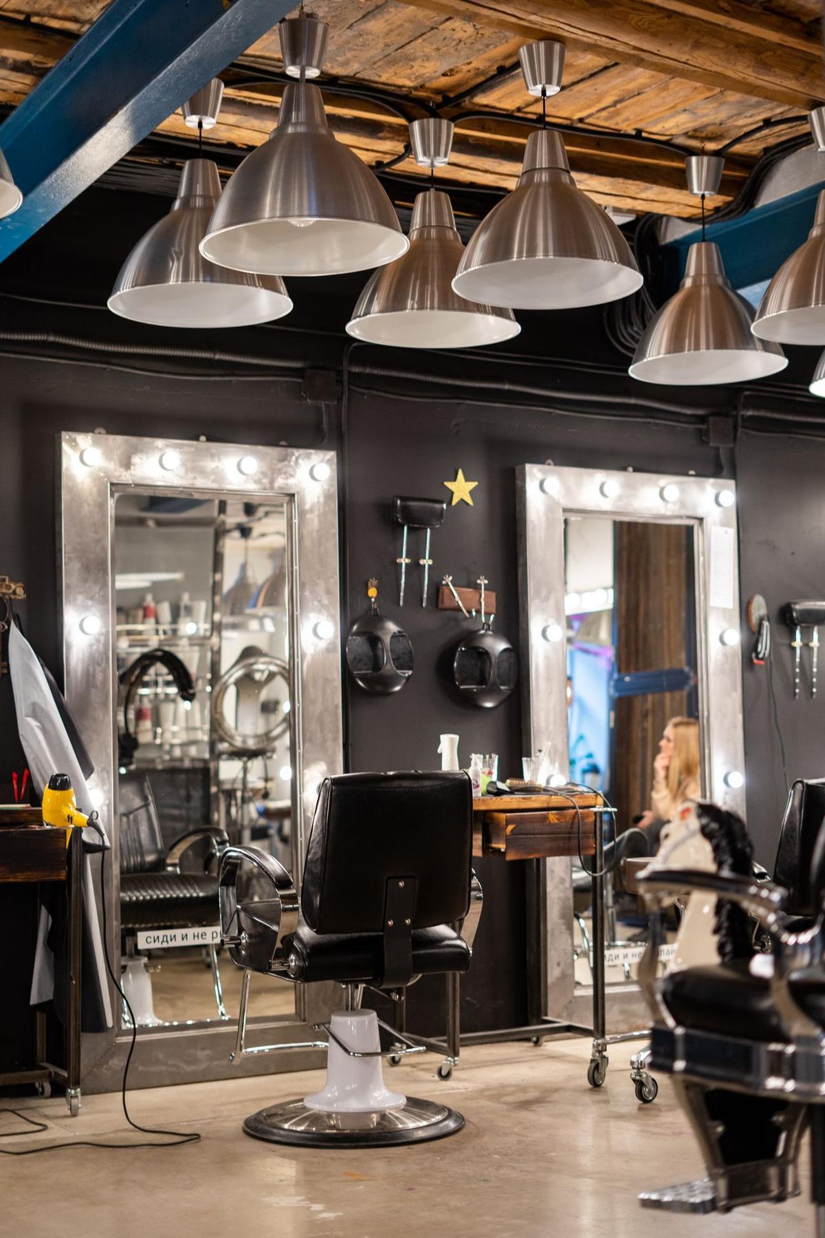 A bright, stylish hair salon interior with chairs and mirrors