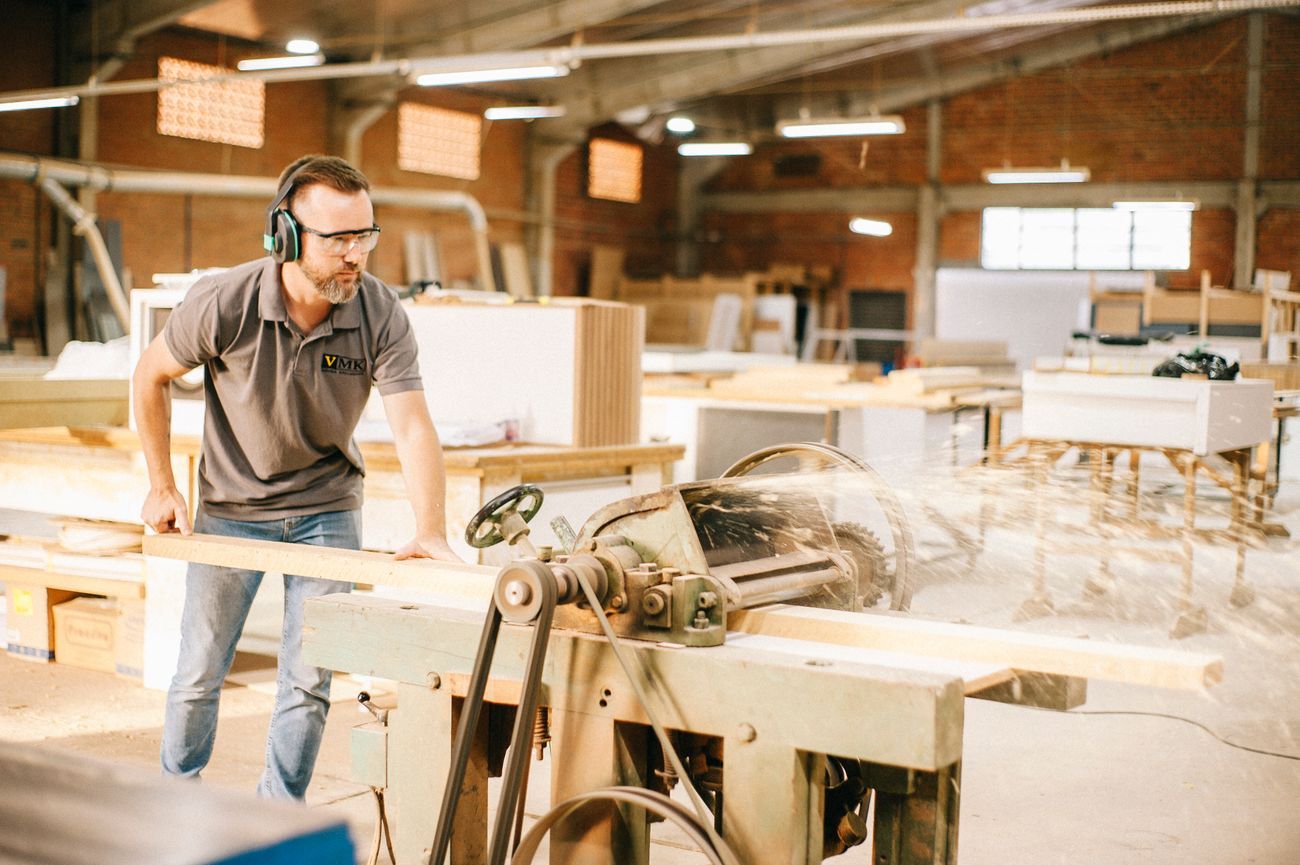 A skilled carpenter working in a woodworking workshop