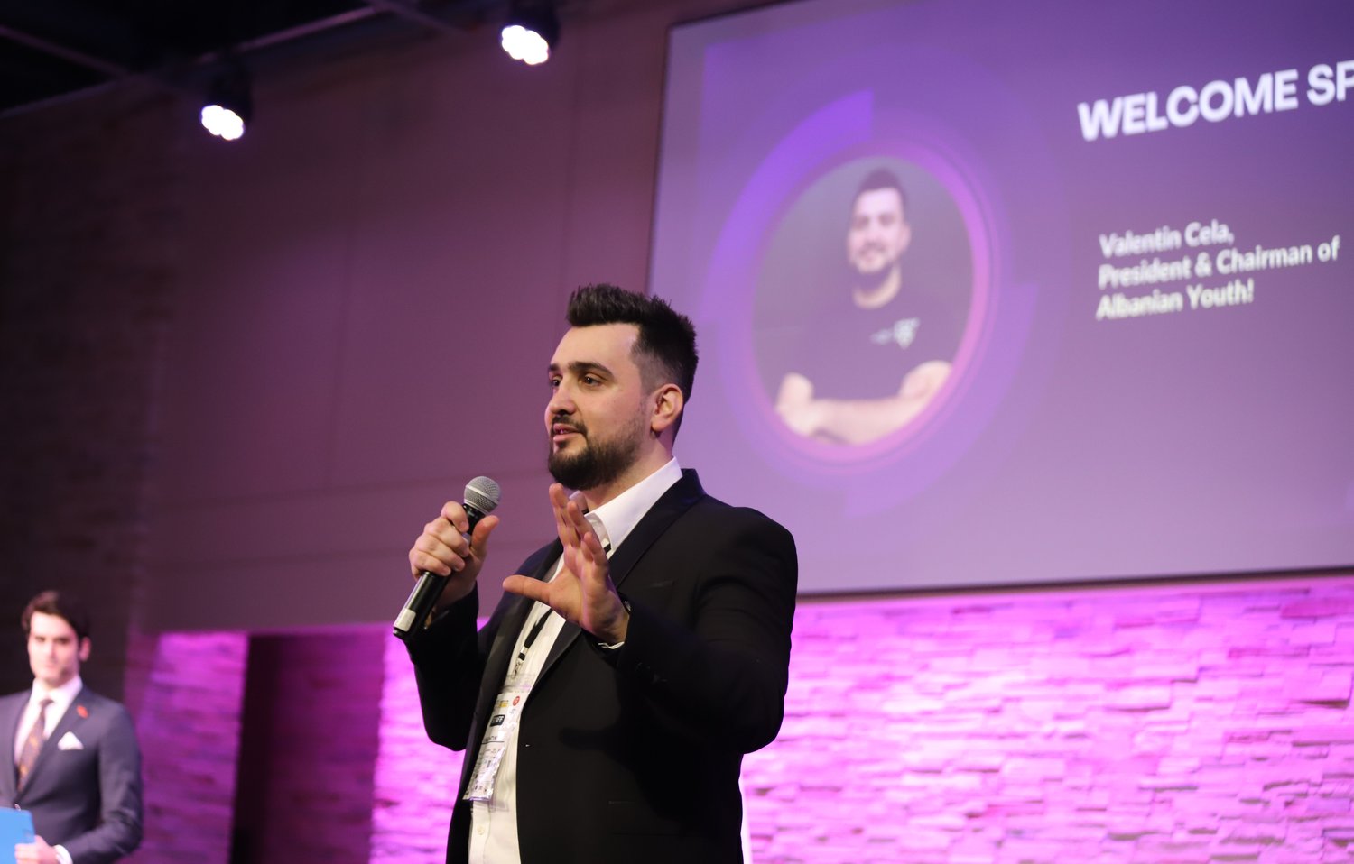 Valentin Cela, Co-Founder of Press and Play, speaking on stage at a community business event